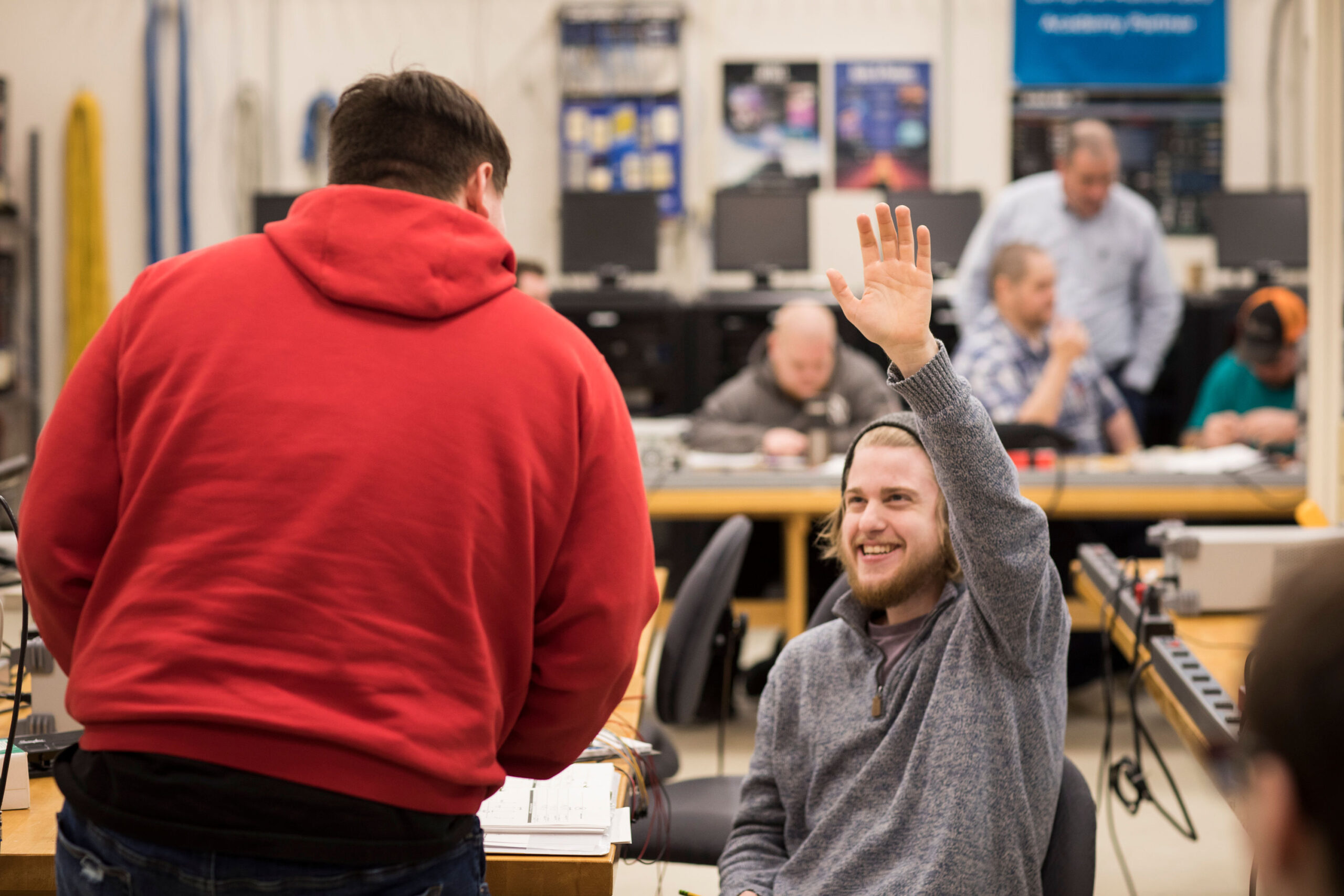 Student raising hand in class