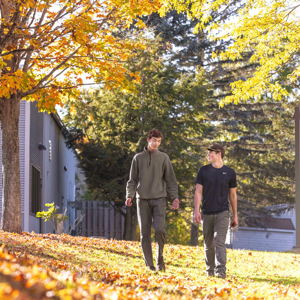 KVCC Students walking with fall leaves
