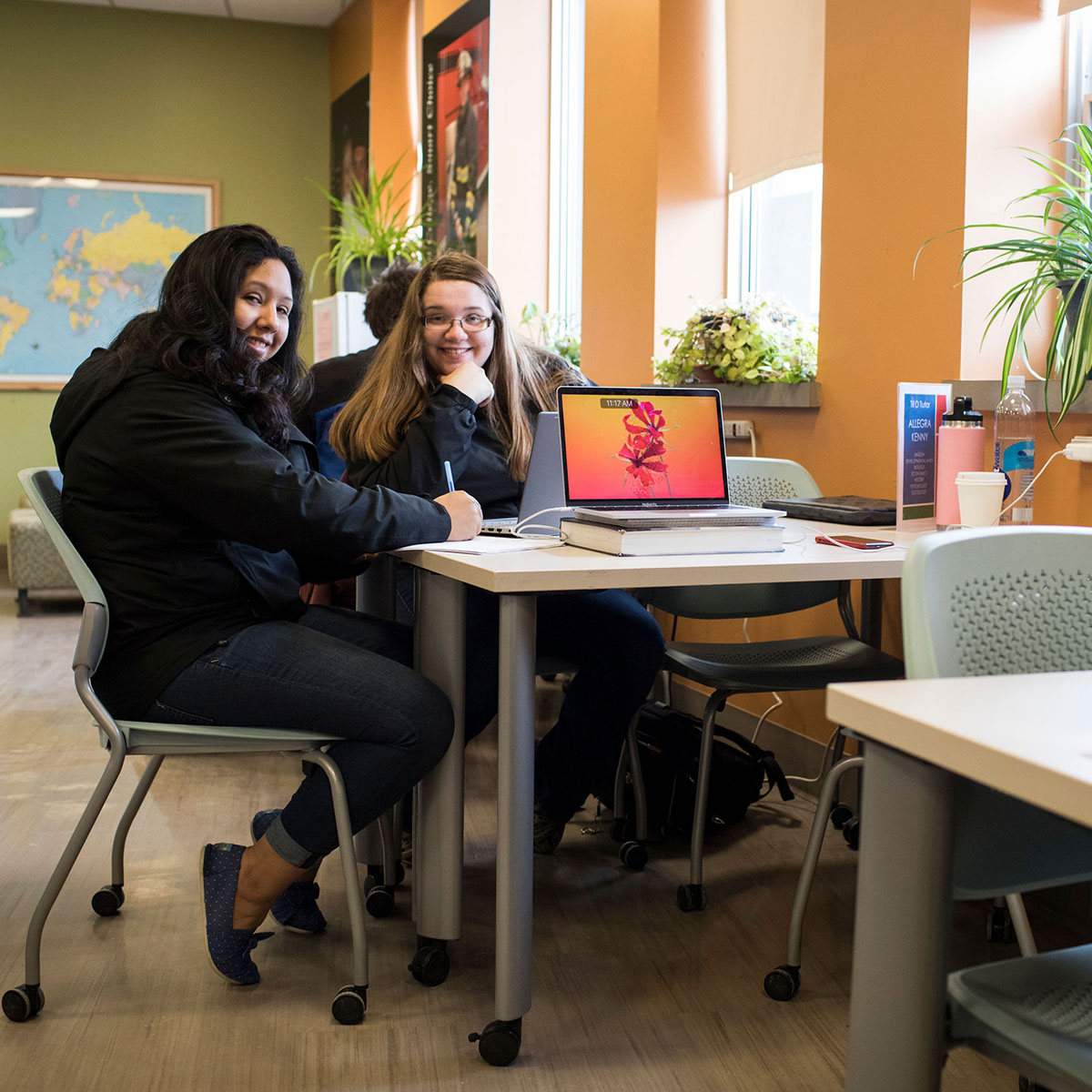 Two students at a table.