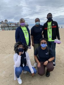 Keep Maine Healthy Ambassadors at Old Orchard Beach this week, masked up and ready to distribute masks and spread the word about COVID-19 safety. (Standing from left) Tracy Taylor, Paulo Paskazia, Beni Lapika; (kneeling from left) Lariska Mali Bengehya and Una Huang.