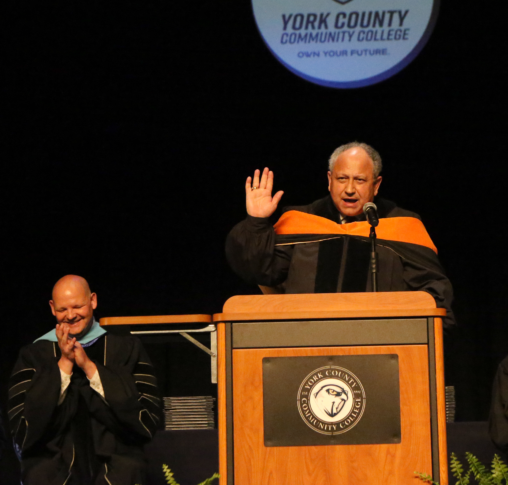 U.S. Secretary of the Navy Carlos Del Toro at the podium at commencement address at York County Community College.